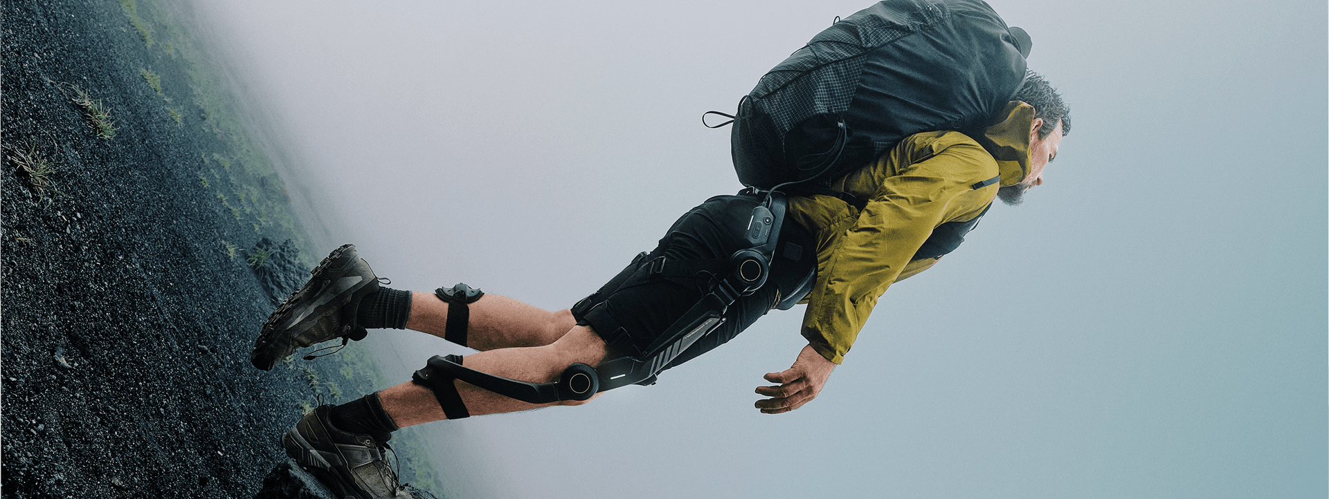 Hiker wearing the Hypershell Halo full-leg powered exoskeleton on a steep trail